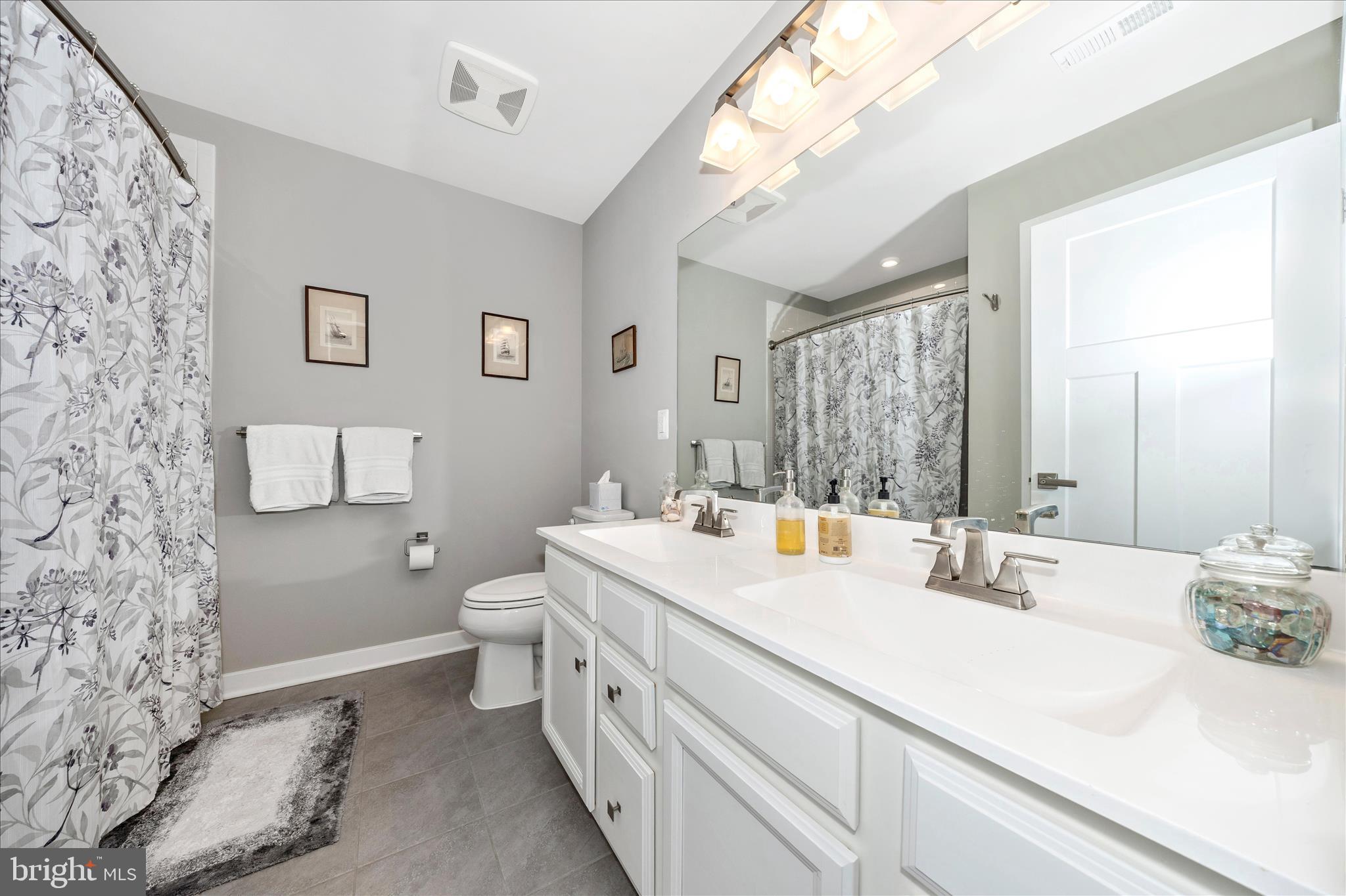 1202 Dargon Quarry Lane Brunswick, MD 21716 - Photo 34 of 76 a bathroom with a double vanity sink toilet and a mirror