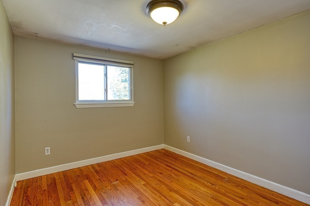 238 West Hill Road Marlborough, MA 01752 - Photo 13 of 30 an empty room with wooden floor and windows