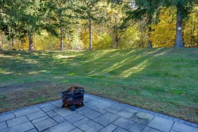 a backyard of a house with table and chairs