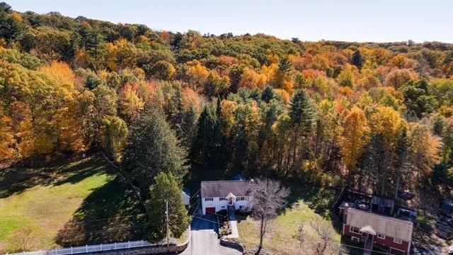an aerial view of a houses with a yard