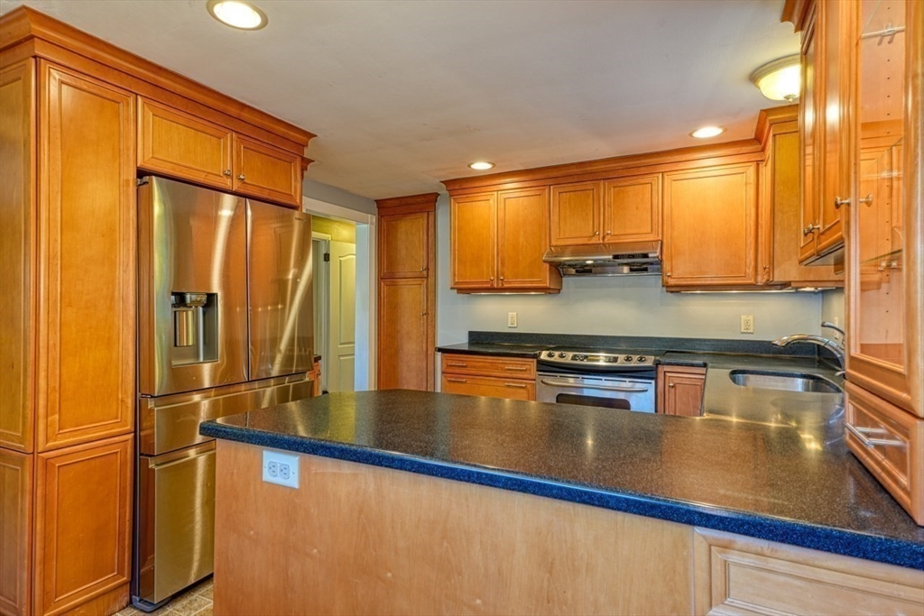 238 West Hill Road Marlborough, MA 01752 - Photo 7 of 30 a kitchen with stainless steel appliances granite countertop a refrigerator a stove and a sink with wooden floor