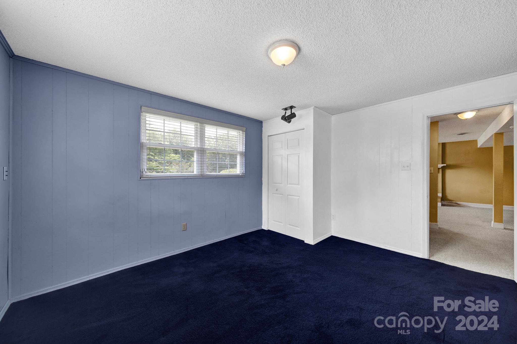 12208 Mapleton Road Charlotte, NC 28273 - Photo 24 of 41 an empty room with wooden floor and a window