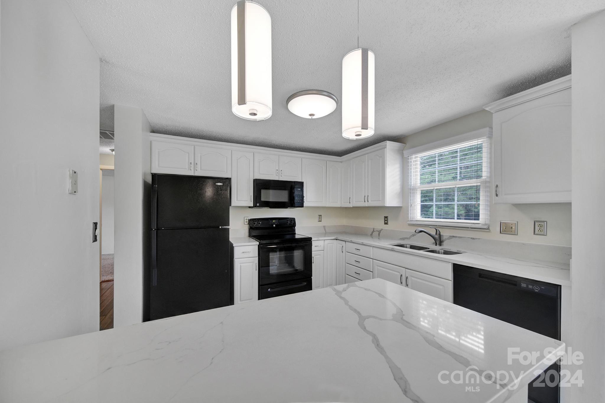 12208 Mapleton Road Charlotte, NC 28273 - Photo 8 of 41 a kitchen with stainless steel appliances granite countertop a refrigerator a stove a sink and a microwave