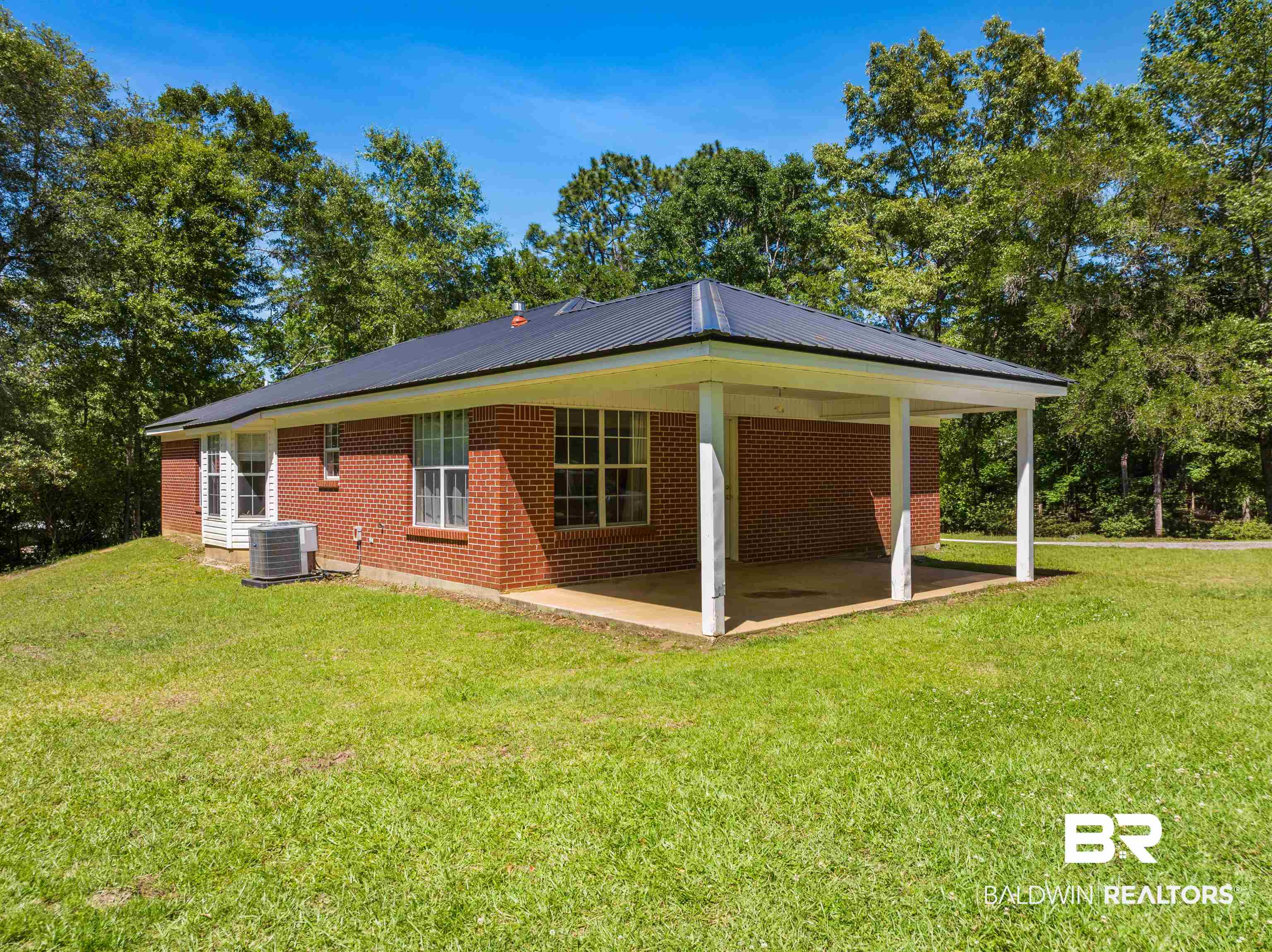 35893 Pine Road South Stapleton, AL 36578 - Photo 5 of 31 Brick exterior with a dark metal roof and white trim