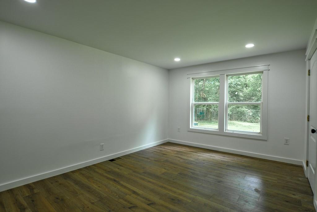 3349 Calhoun Road Northeast Rome, GA 30161 - Photo 14 of 30 an empty room with wooden floor and windows