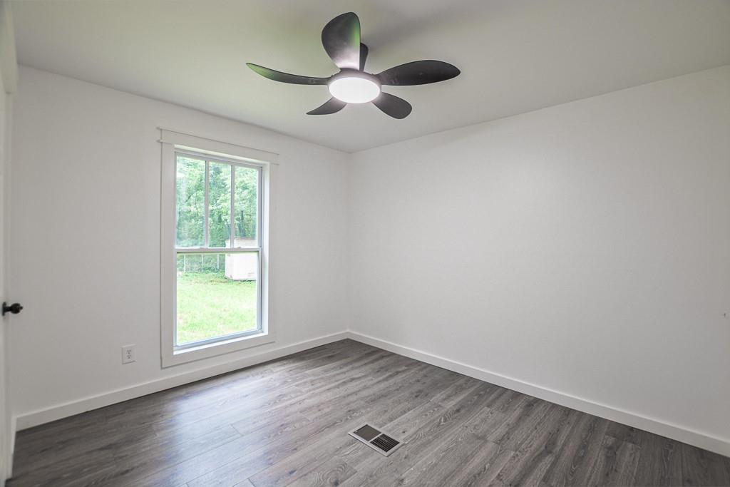 3349 Calhoun Road Northeast Rome, GA 30161 - Photo 18 of 30 an empty room with wooden floor and windows