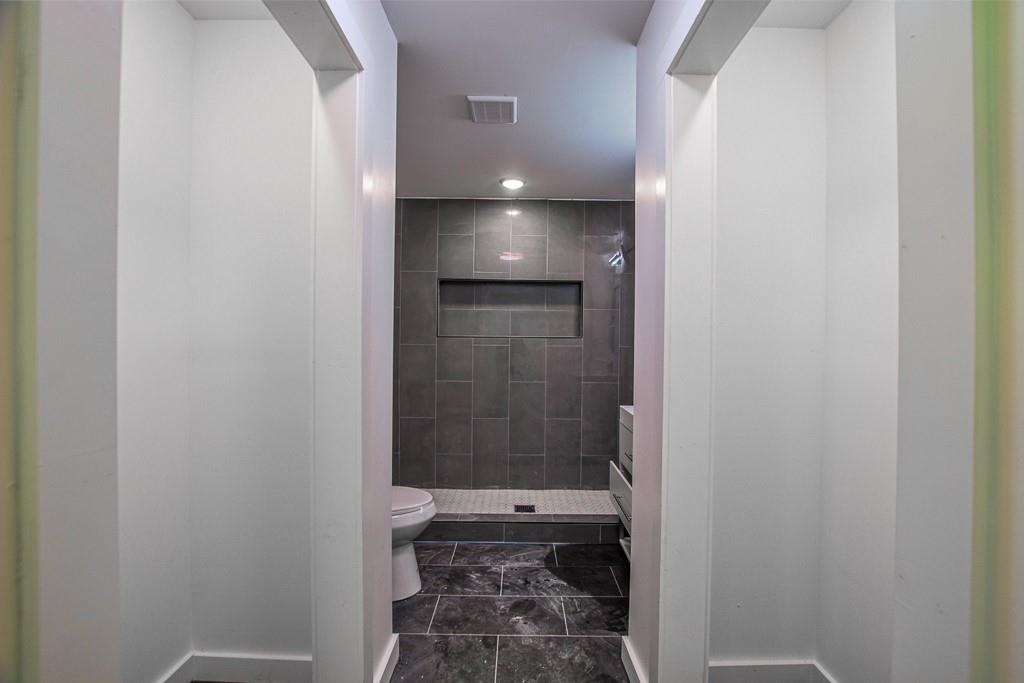 3349 Calhoun Road Northeast Rome, GA 30161 - Photo 23 of 30 a bathroom with a glass shower door