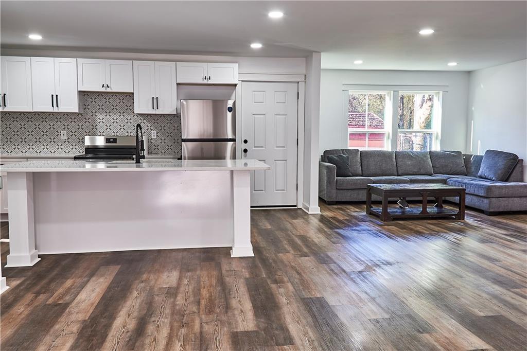 3349 Calhoun Road Northeast Rome, GA 30161 - Photo 8 of 30 a living room with furniture and kitchen view