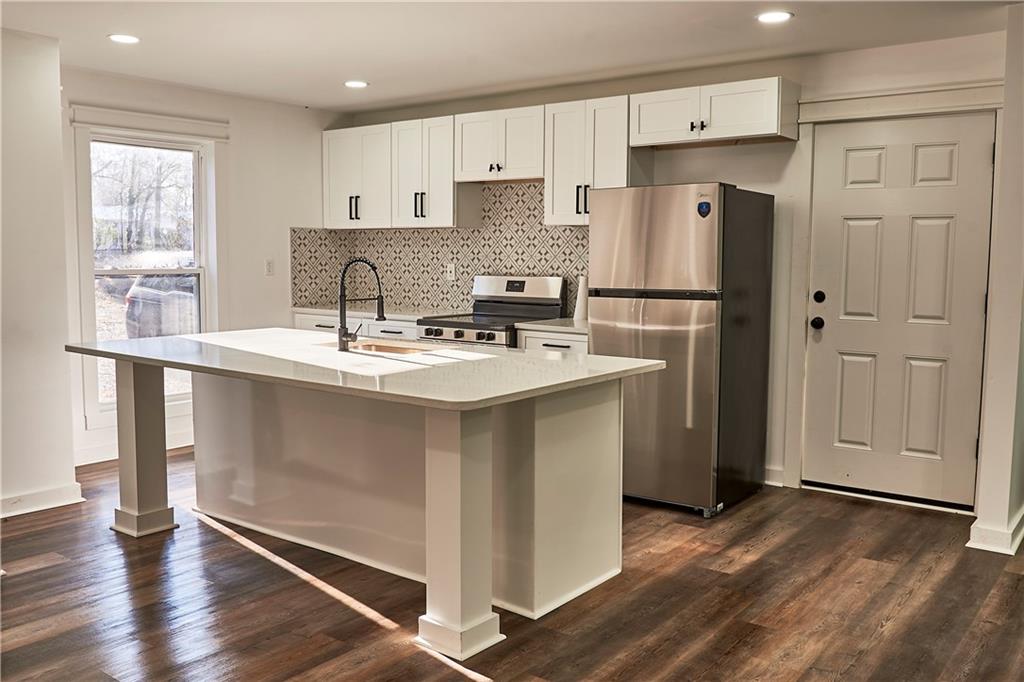 3349 Calhoun Road Northeast Rome, GA 30161 - Photo 10 of 30 a kitchen with stainless steel appliances granite countertop a refrigerator sink and cabinets