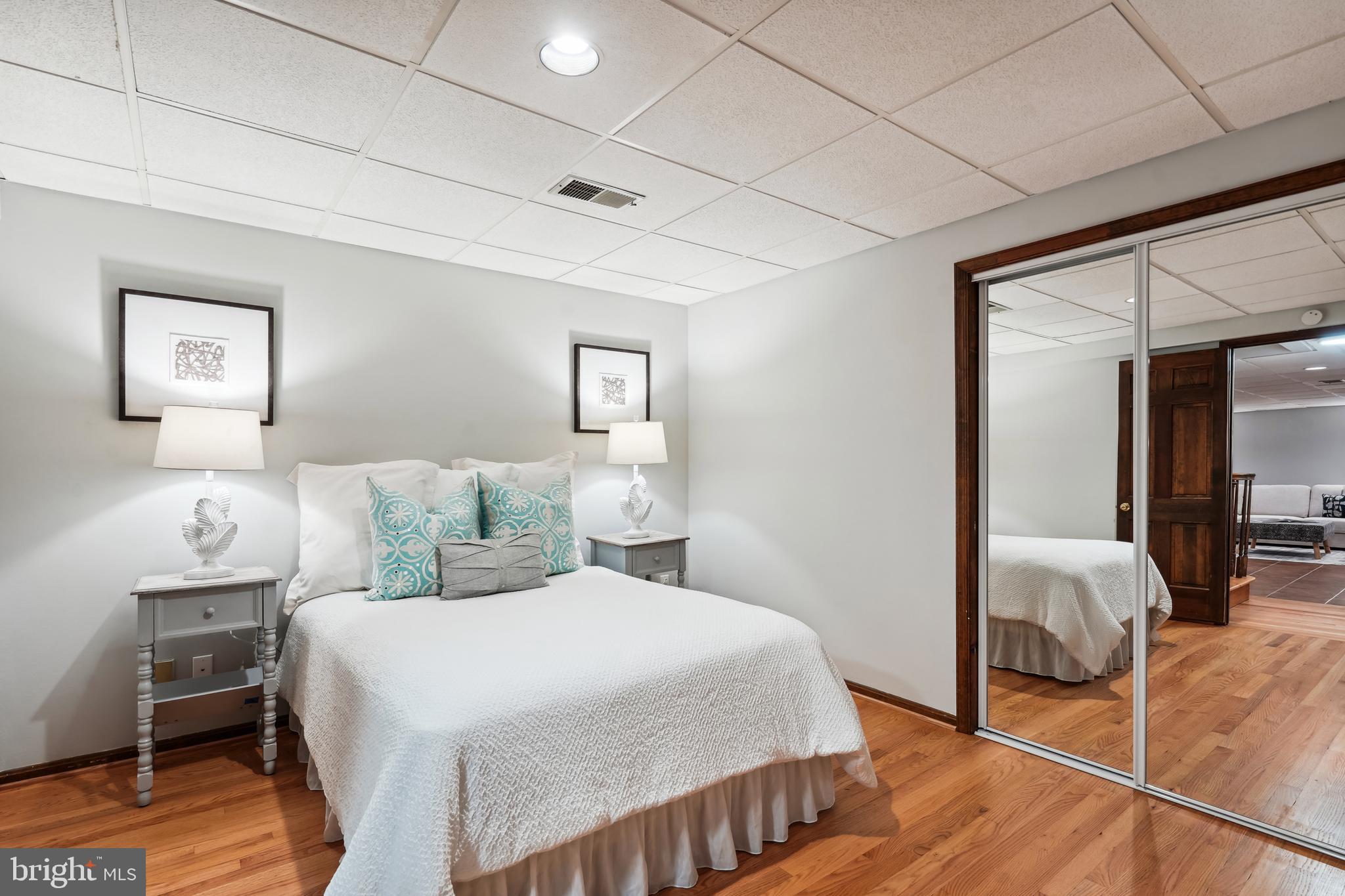 2559 Five Oaks Road Vienna, VA 22181 - Photo 40 of 55 a bedroom with a bed and wooden floor