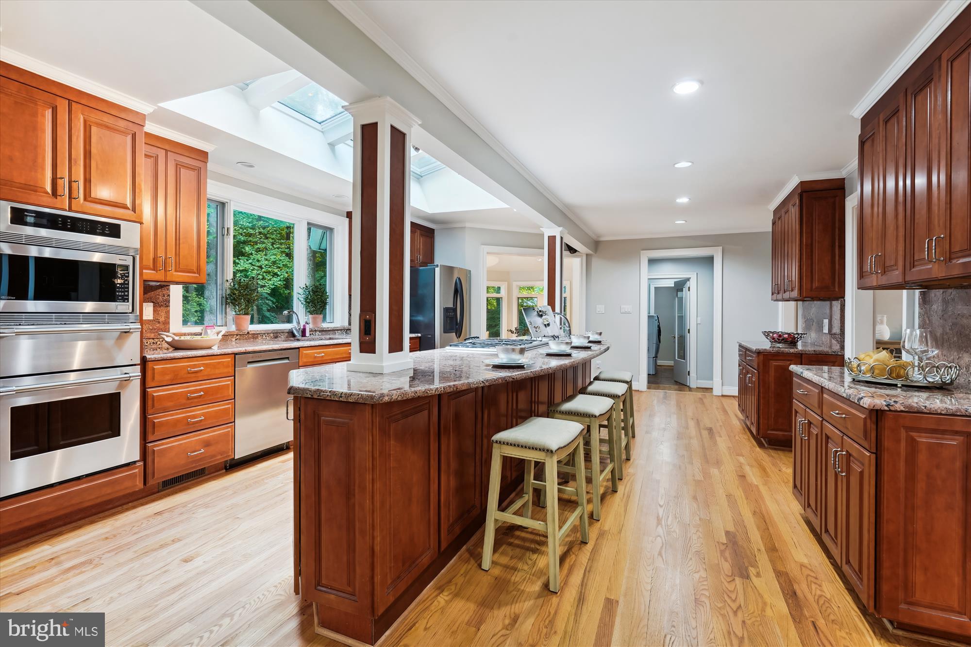2559 Five Oaks Road Vienna, VA 22181 - Photo 6 of 55 a kitchen with stainless steel appliances granite countertop wooden floors and sink