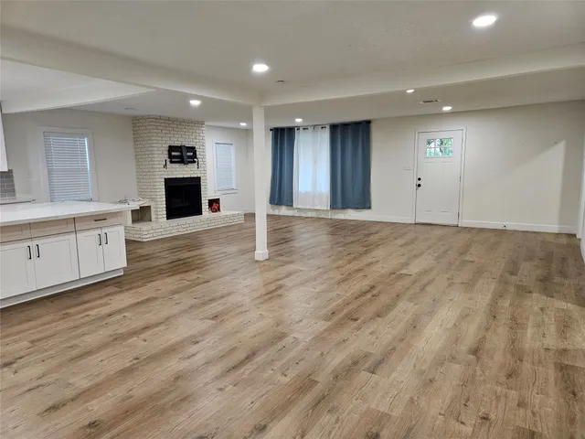 a view of an empty room with a kitchen
