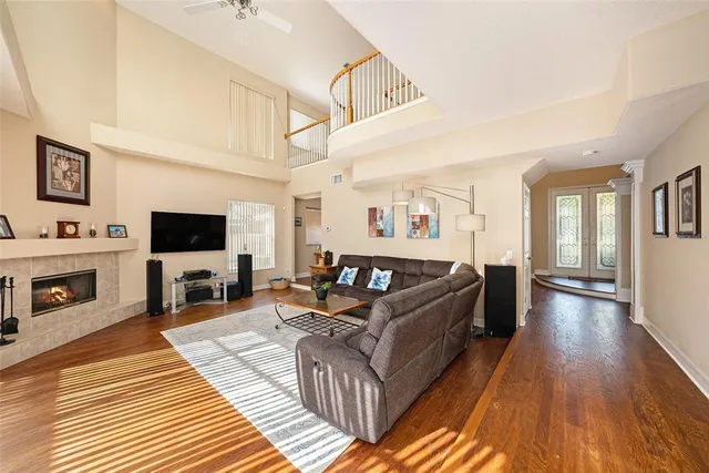 a living room with furniture a flat screen tv and a fireplace