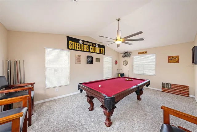 a room with furniture pool table and flat screen tv