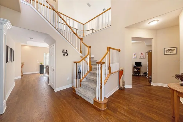 a view of entryway with wooden floor and stairs
