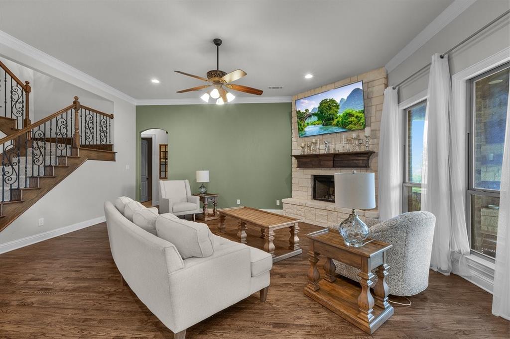 228 Parc Oaks Drive Aledo, TX 76008 - Photo 11 of 40 a living room with furniture a fireplace and a flat screen tv