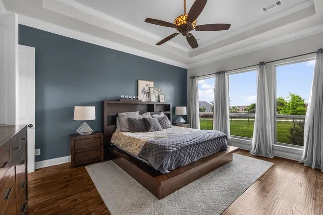 a bedroom with a large bed and a large window