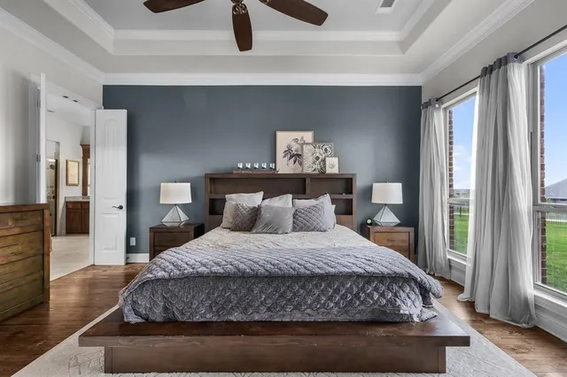 a bedroom with a large bed and a chandelier