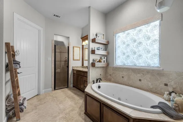a bathroom with a bathtub and a shower
