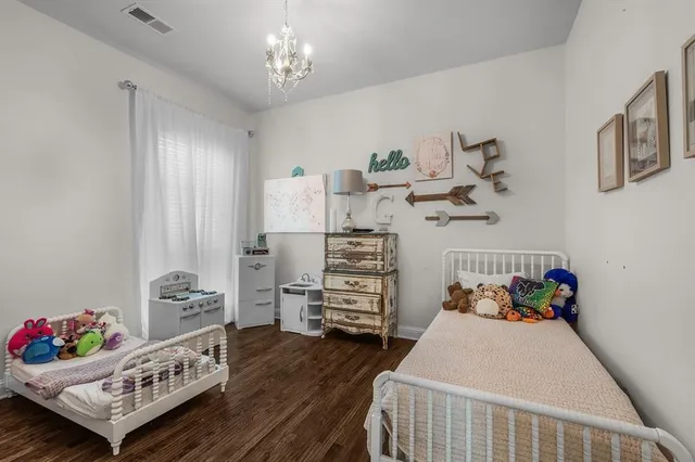 a bedroom with furniture and a wooden floor