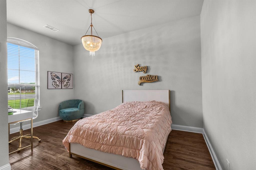 228 Parc Oaks Drive Aledo, TX 76008 - Photo 21 of 40 a bedroom with a bed and a window