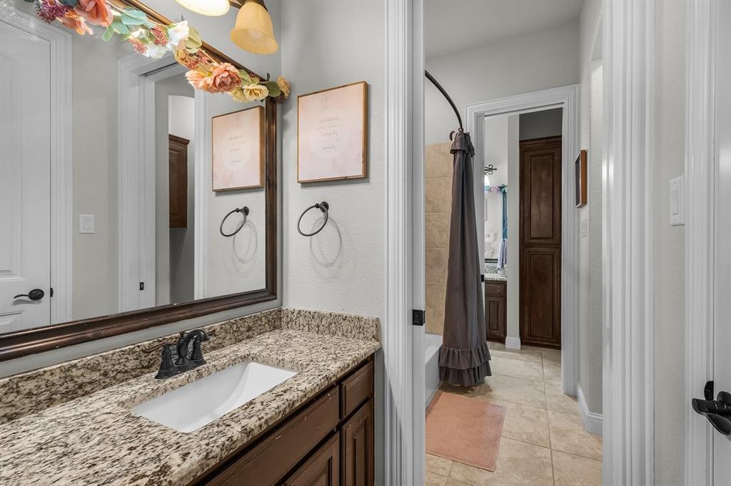 228 Parc Oaks Drive Aledo, TX 76008 - Photo 22 of 40 a bathroom with a granite countertop sink and a mirror