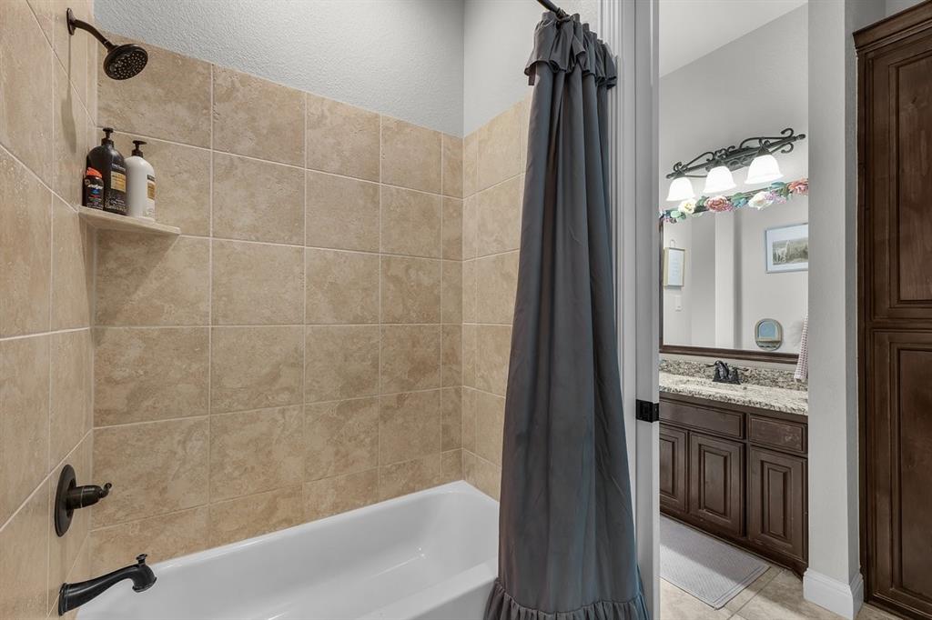 228 Parc Oaks Drive Aledo, TX 76008 - Photo 23 of 40 a bathroom with a bathtub and a shower