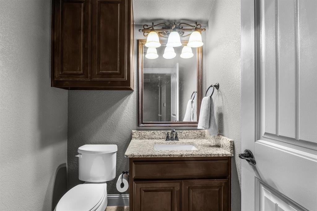 228 Parc Oaks Drive Aledo, TX 76008 - Photo 27 of 40 a bathroom with a granite countertop sink and a mirror