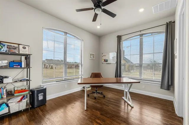 a view of a workspace with furniture and a window
