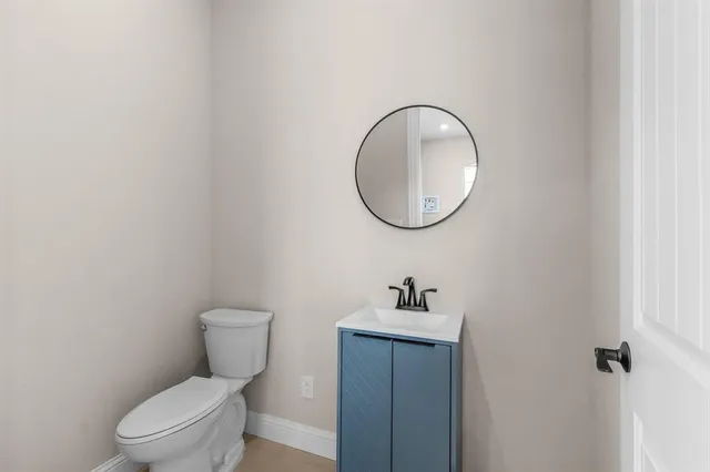 a white toilet sitting next to a bathroom sink
