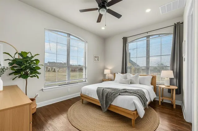 a bedroom with a large bed and a window
