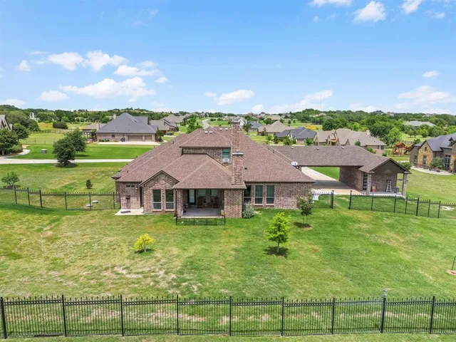 aerial view of a house with big yard
