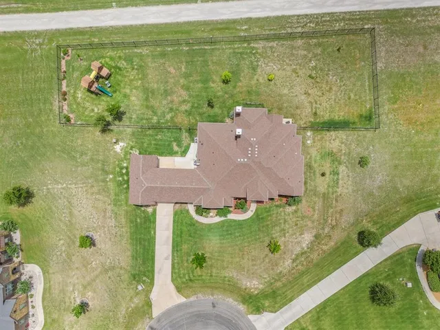 an aerial view of residential houses with outdoor space and swimming pool