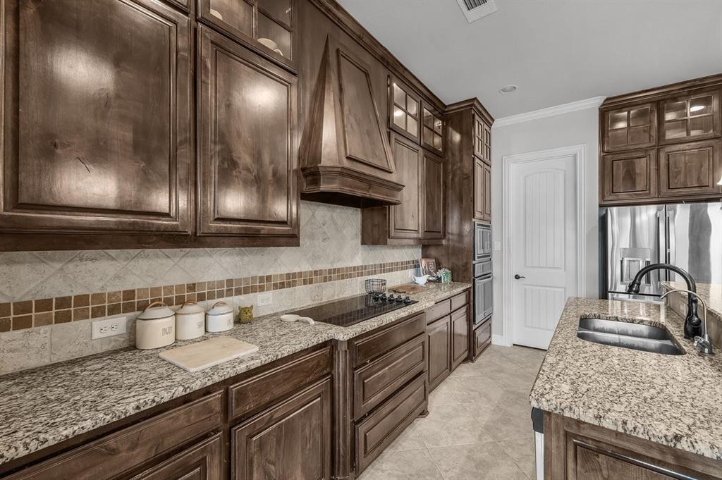 228 Parc Oaks Drive Aledo, TX 76008 - Photo 5 of 40 a kitchen with granite countertop stainless steel appliances a sink stove and cabinets