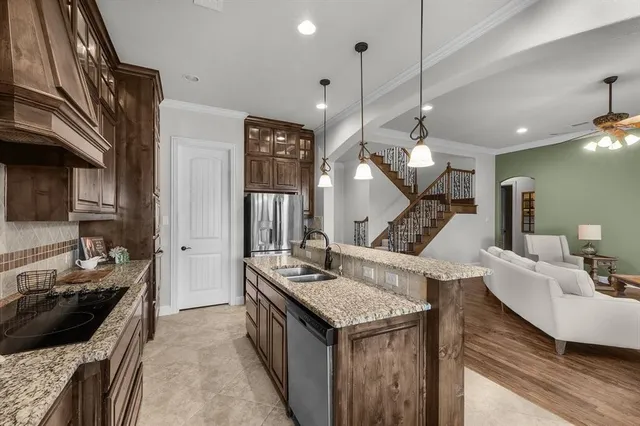 a kitchen with a stove and a wooden floor