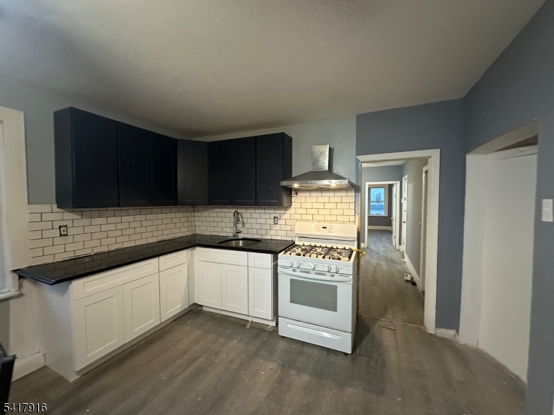 426 Franklin Street, Unit 2 Elizabeth Port, NJ 07206 - Photo 1 of 18 a kitchen with stainless steel appliances a sink stove and microwave