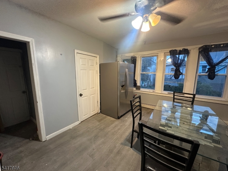 426 Franklin Street, Unit 2 Elizabeth Port, NJ 07206 - Photo 2 of 18 a view of a dining room with furniture a chandelier and wooden floor