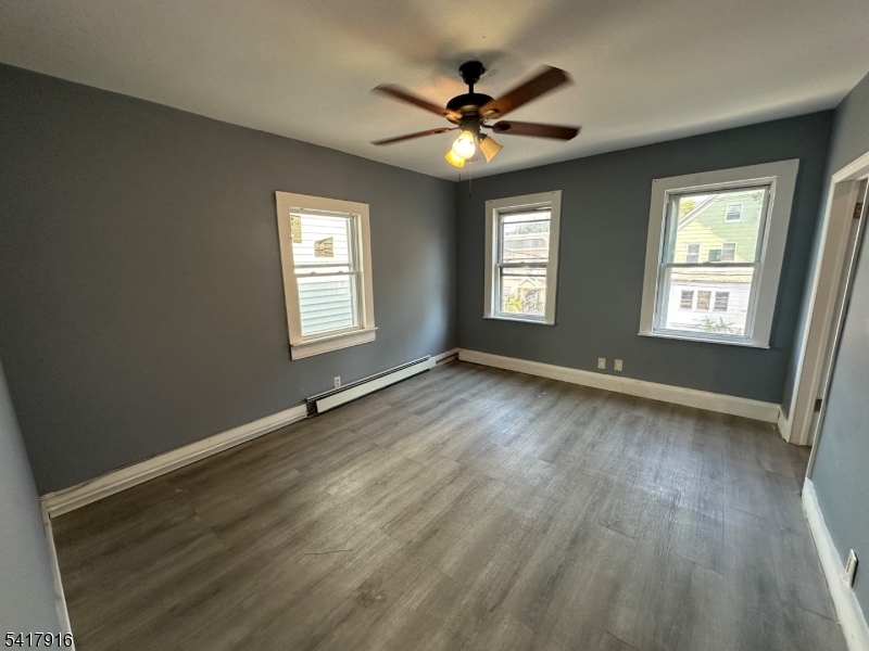 426 Franklin Street, Unit 2 Elizabeth Port, NJ 07206 - Photo 8 of 18 a view of an empty room with a window and wooden floor