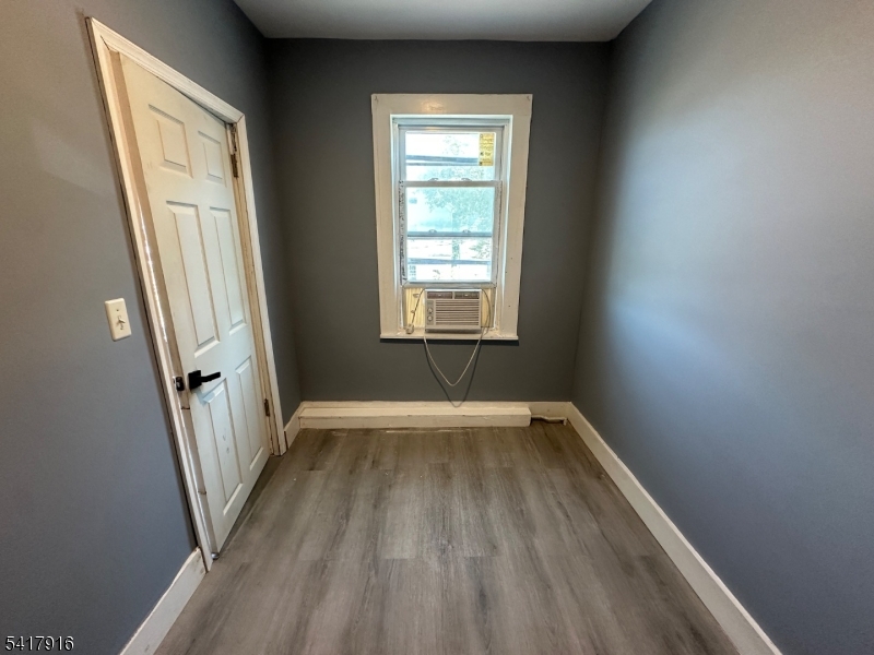 426 Franklin Street, Unit 2 Elizabeth Port, NJ 07206 - Photo 9 of 18 an empty room with wooden floor and windows