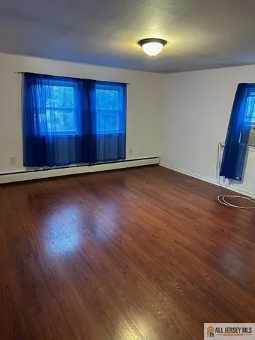 a view of a room with wooden floor