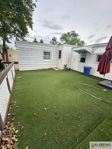a view of a table and chairs in patio with wooden fence