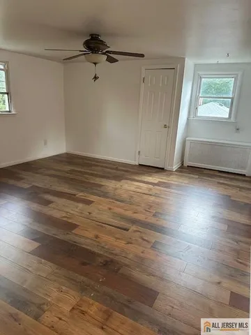 a view of room with hardwood floor and window