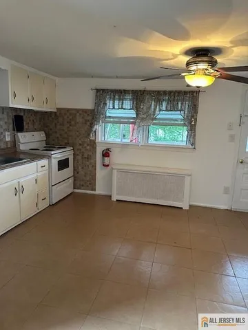 a kitchen with a refrigerator sink stove and cabinets