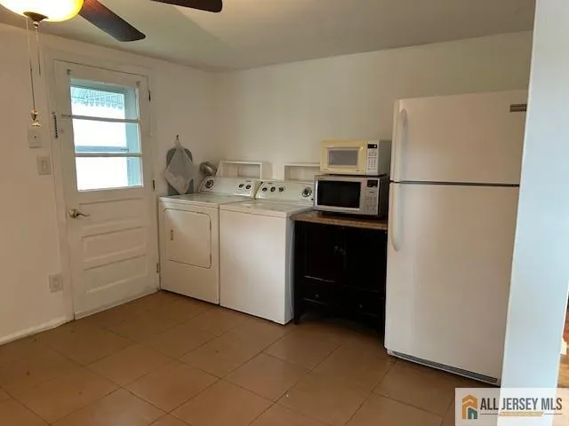 a view of a hallway with wooden floor and a bathroom