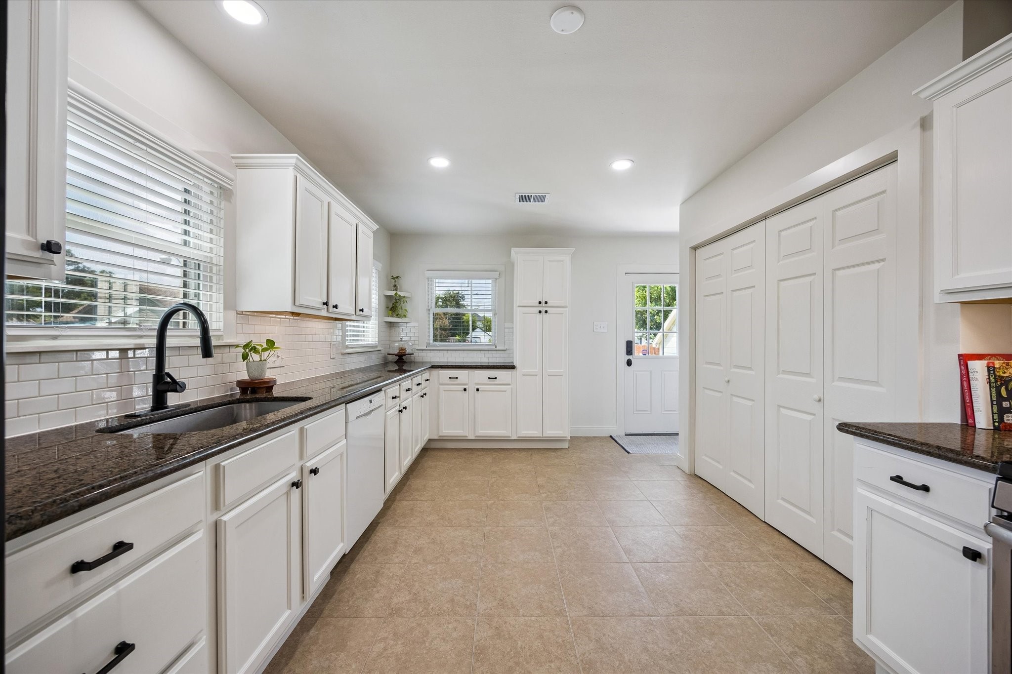 809 Gale Street Houston, TX 77009 - Photo 9 of 18 Functional gallery style kitchen with extensive cabinetry, ample counter space, and abundant natural light.