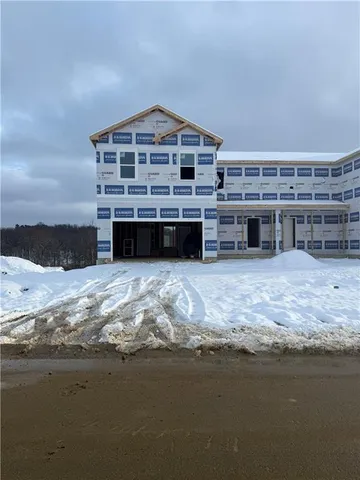 a view of a house with a yard and sitting area