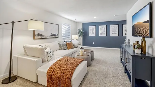 a living room with furniture a lamp and a window