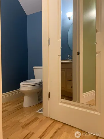 a bathroom with a toilet and a mirror