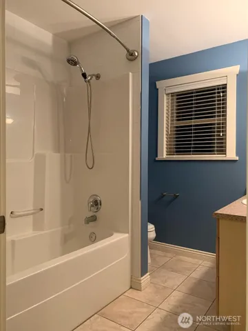 a bedroom with a bed dresser and a window