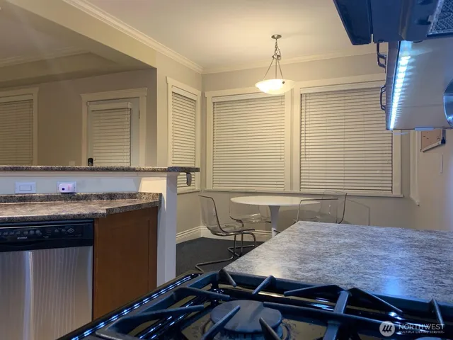 a kitchen with a table and chairs in it